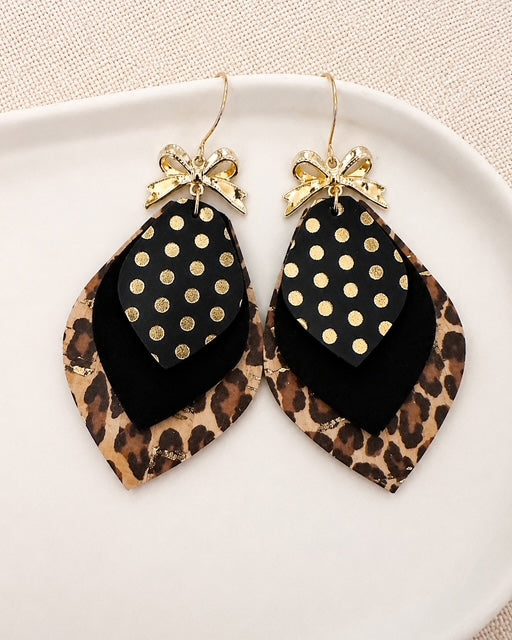 Handmade Leopard Glam Earrings in black, leopard print and metallic gold displayed on an ivory dish