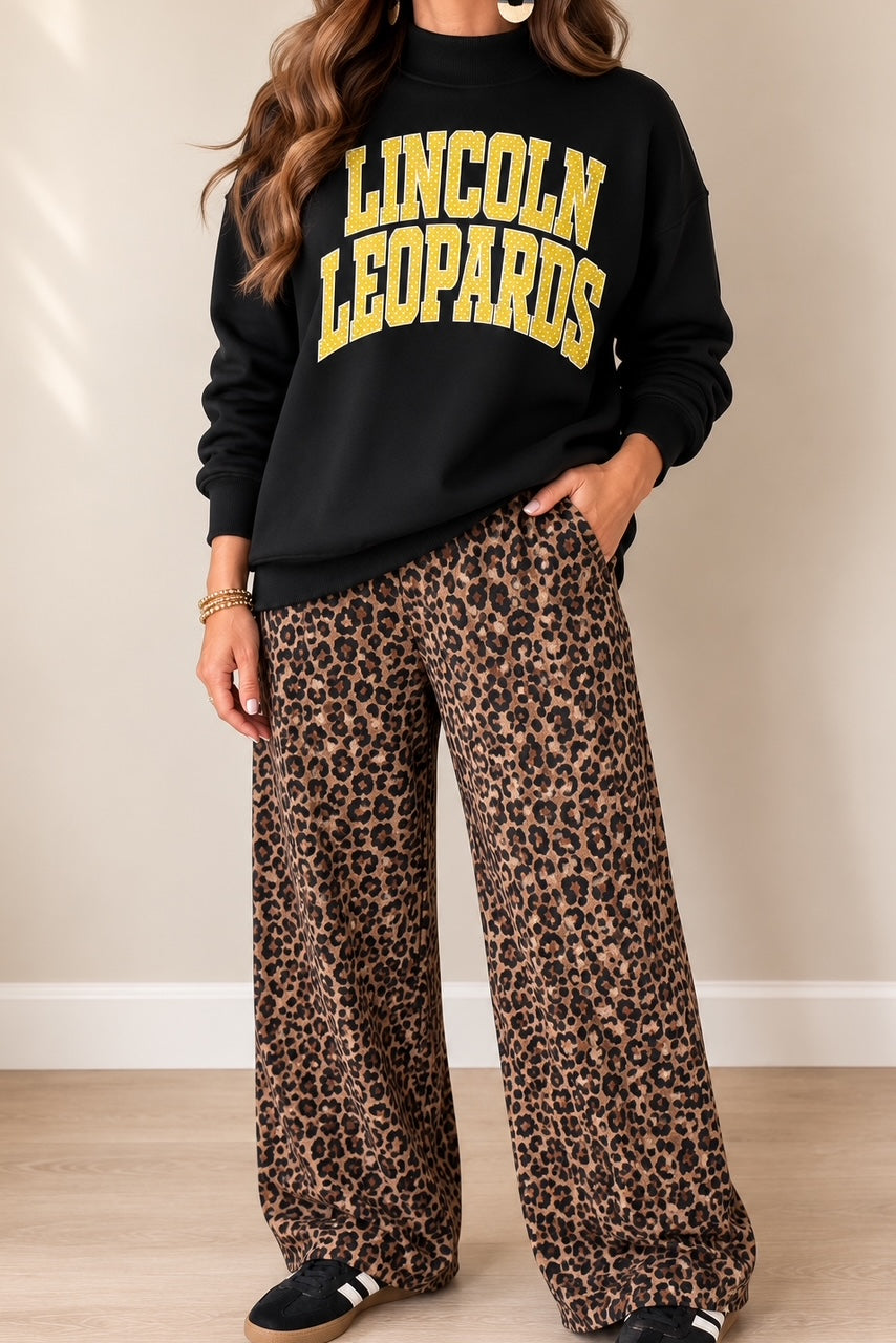 Woman wearing the intentionally oversized black Leopard Legacy Mockneck
