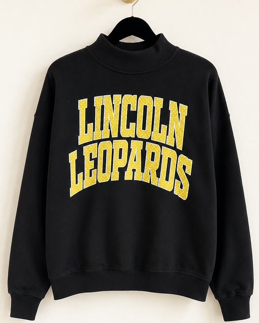 Black Leopard Legacy Mockneck on a hanger showing its oversized silhouette
