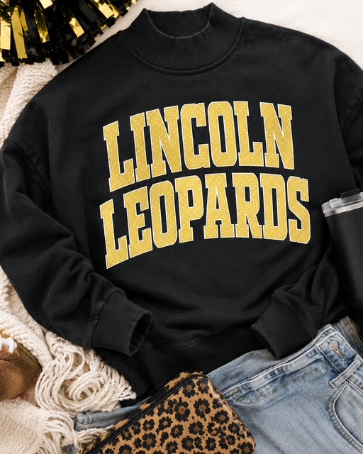 Black Leopard Legacy Mockneck styled with denim and leopard-print accessories
