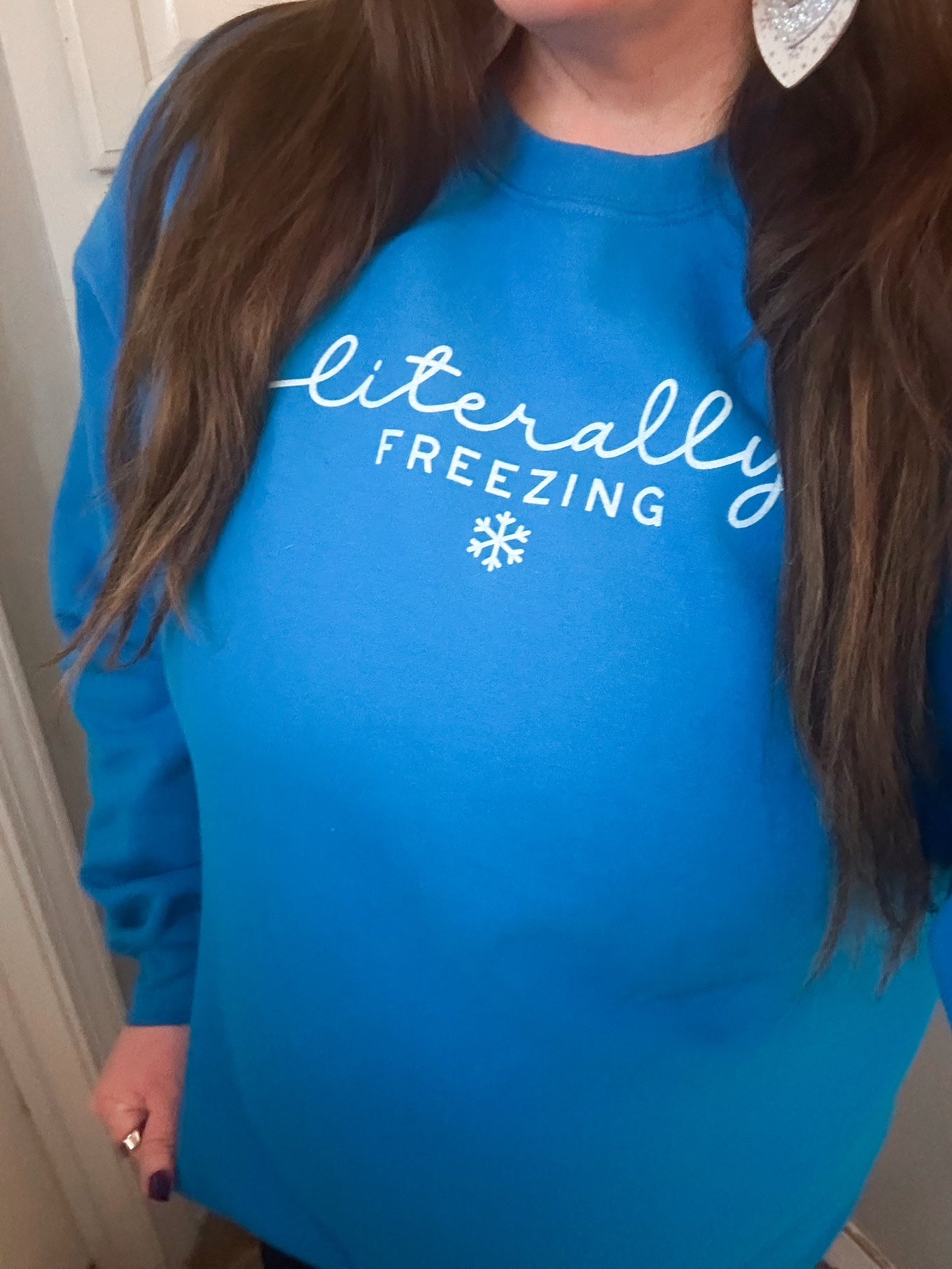 Glacier blue crewneck sweatshirt with white “Literally Freezing” text and a small snowflake graphic.