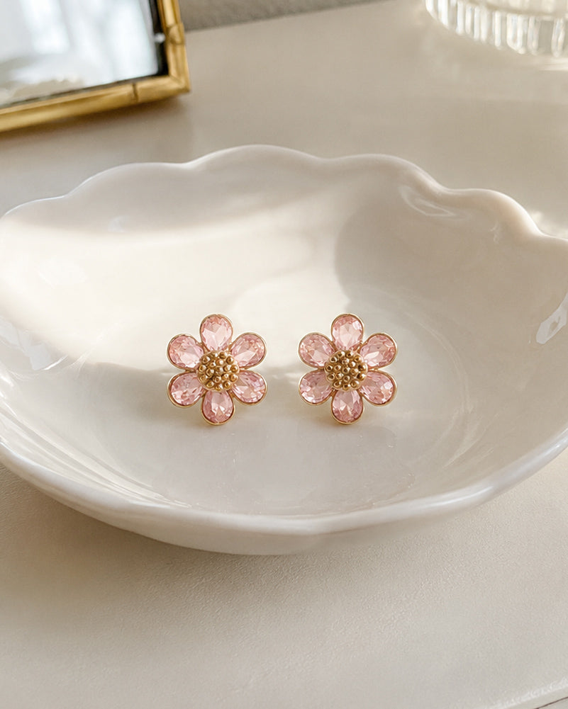 Morning Bloom blush pink flower stud earrings resting on a white ceramic jewelry dish