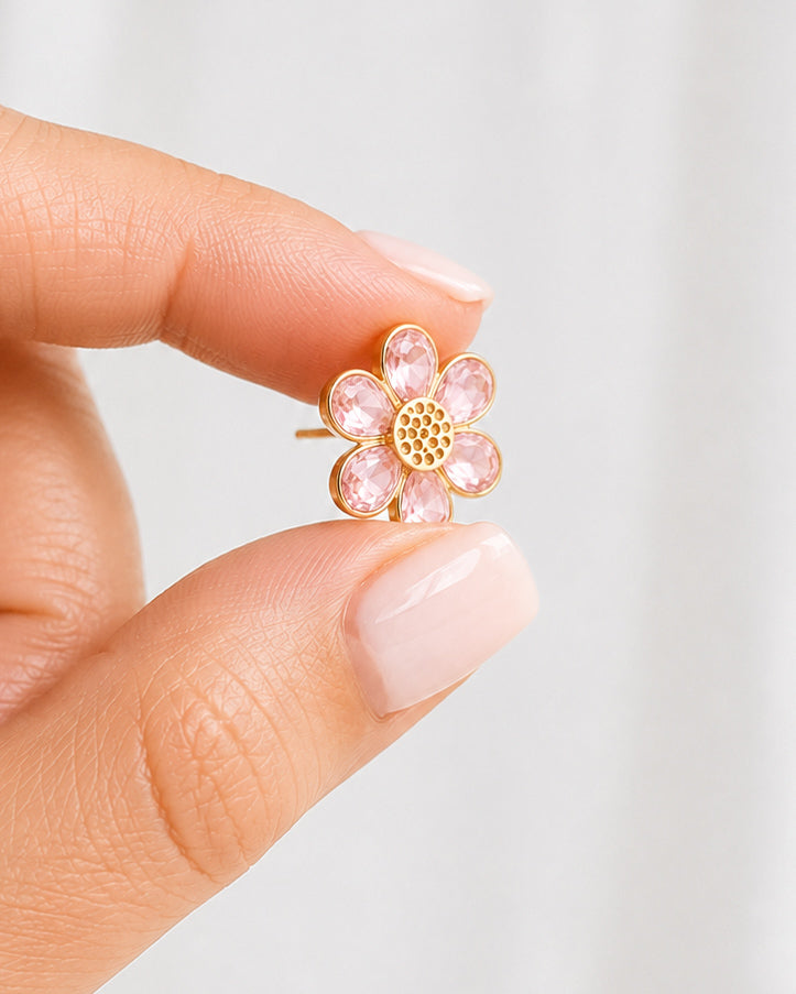 Morning Bloom pink flower stud earrings shown in hand for size reference