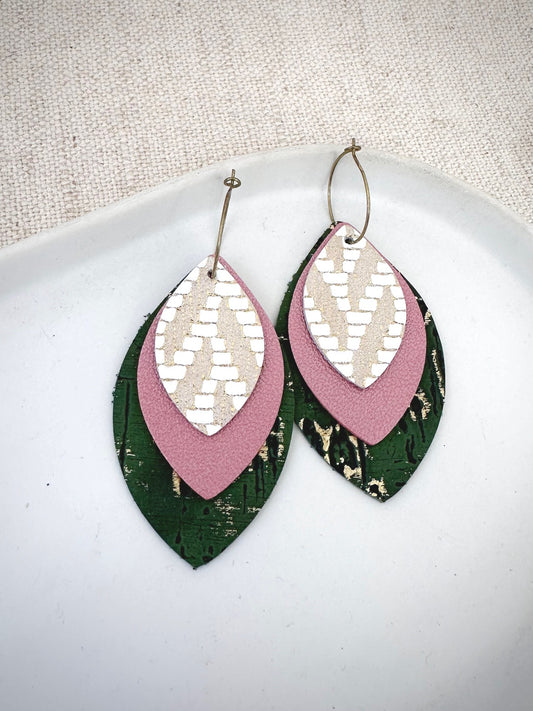 Genuine leather layered hoop earrings with white and gold patterned leather top layer, blush pink pearlized leather middle layer, and moss green leather bottom layer with metallic gold distressing.