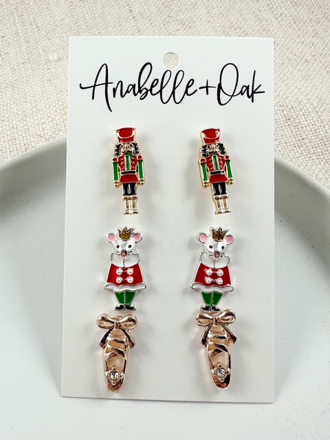 Close-up of Nutcracker, Rat King, and pointe shoe stud earrings showing detailed design