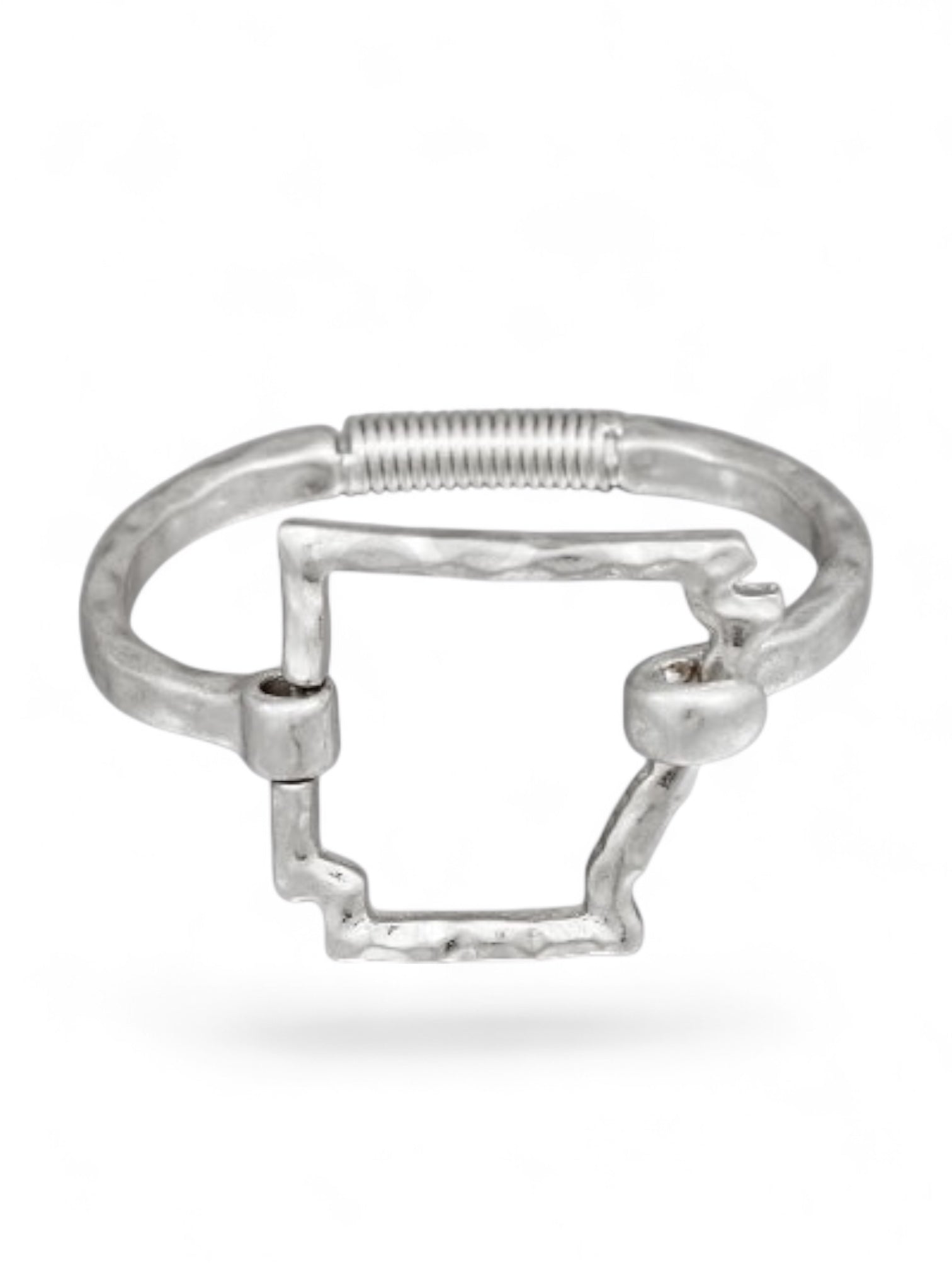 Worn silver hammered outline cuff bracelet with hinged closure displayed on a white background.