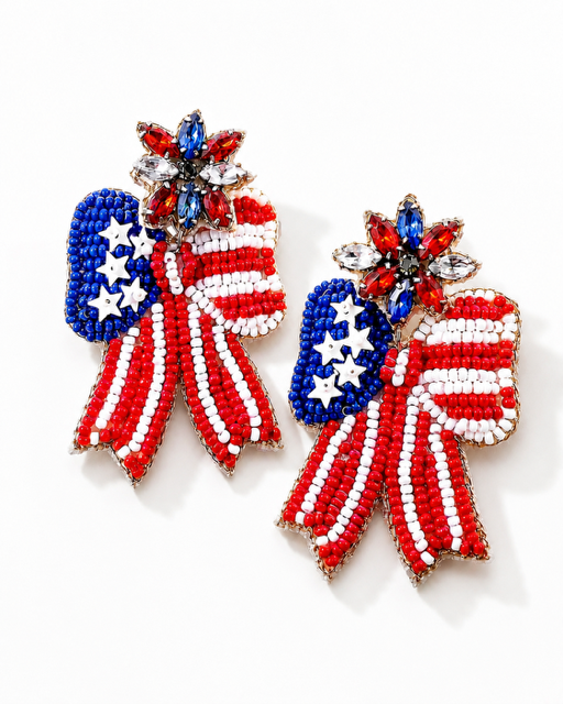 Close-up of Patriotic Bow Earrings featuring red, white, and blue seed bead bows with rhinestone floral post details.