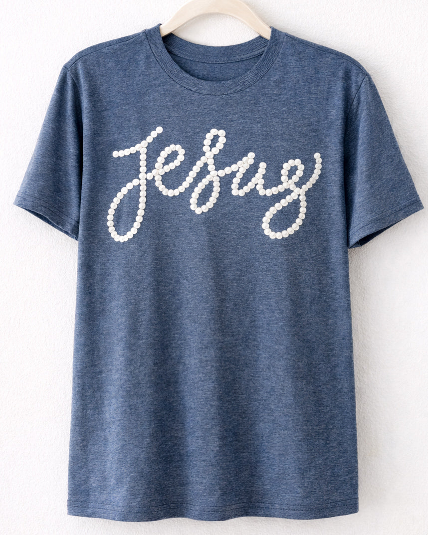Heather navy Tultex t shirt on hanger with white pearl style Jesus text on front