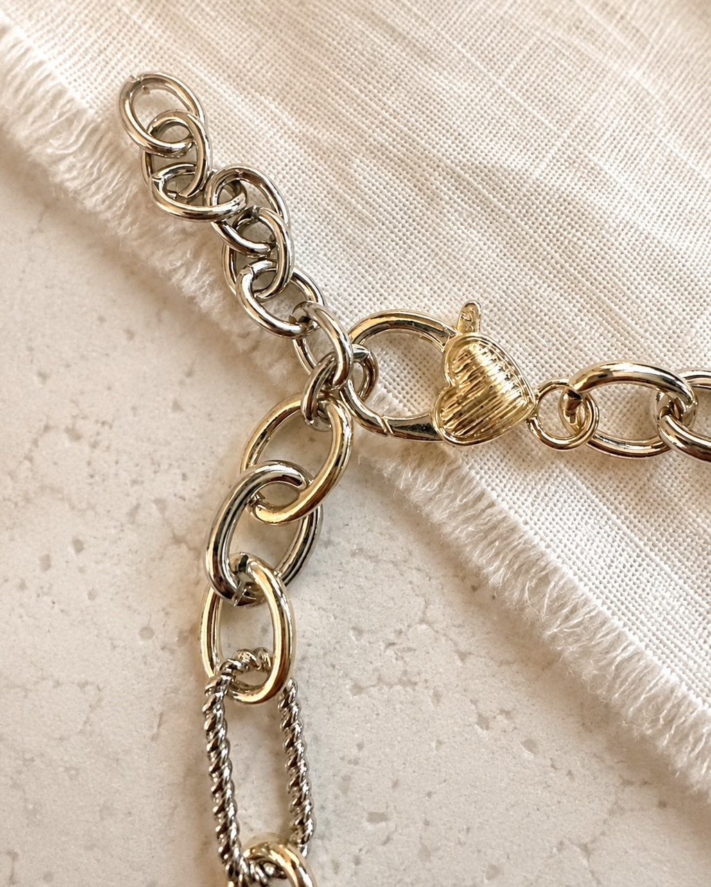 Plot Twist Necklace heart-shaped lobster clasp and 2-inch silver extender with mixed gold and silver links