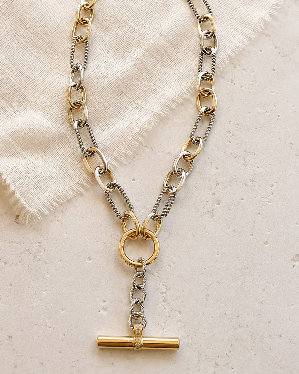 Detail of the Plot Twist Necklace showing mixed gold and silver links and textured silver chain sections