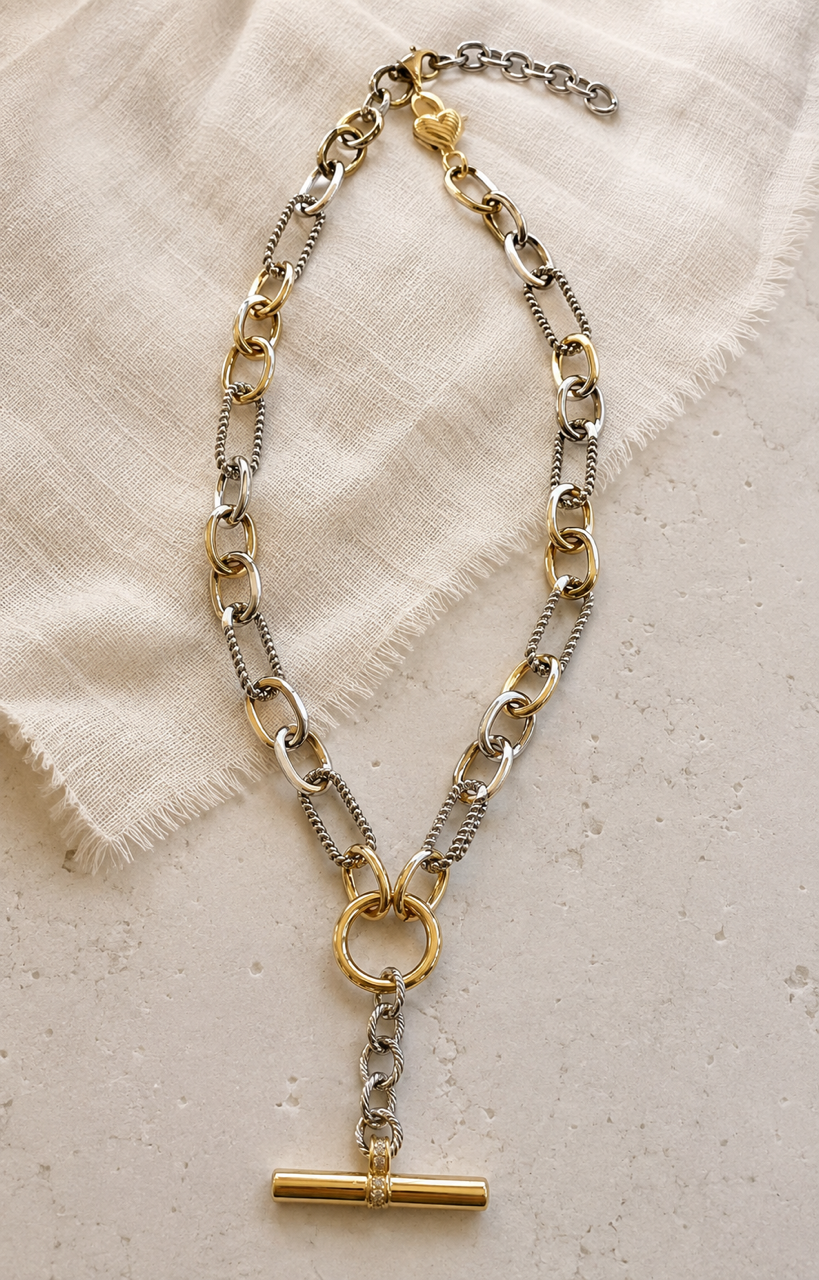 Full view of the Plot Twist mixed metal necklace with 2-inch extender, heart lobster clasp and T-bar Y-drop