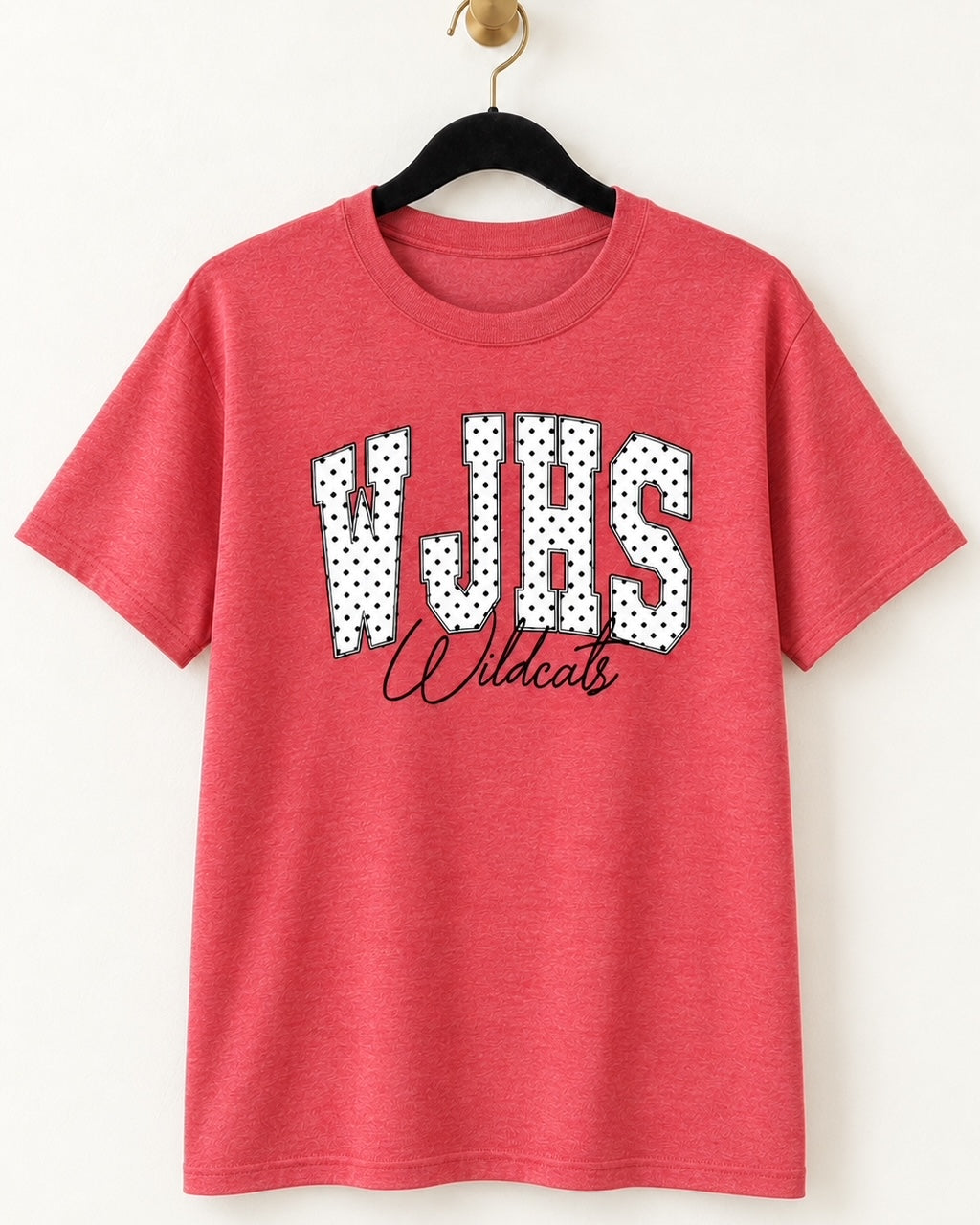 Heather red WJHS Wildcats short-sleeve graphic tee with white polka-dot varsity lettering and black Wildcats script on a hanger.