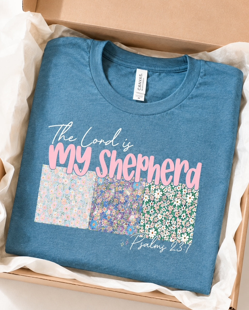 Shepherd's Garden Tee folded in a white boutique gift box with coordinating floral earrings.