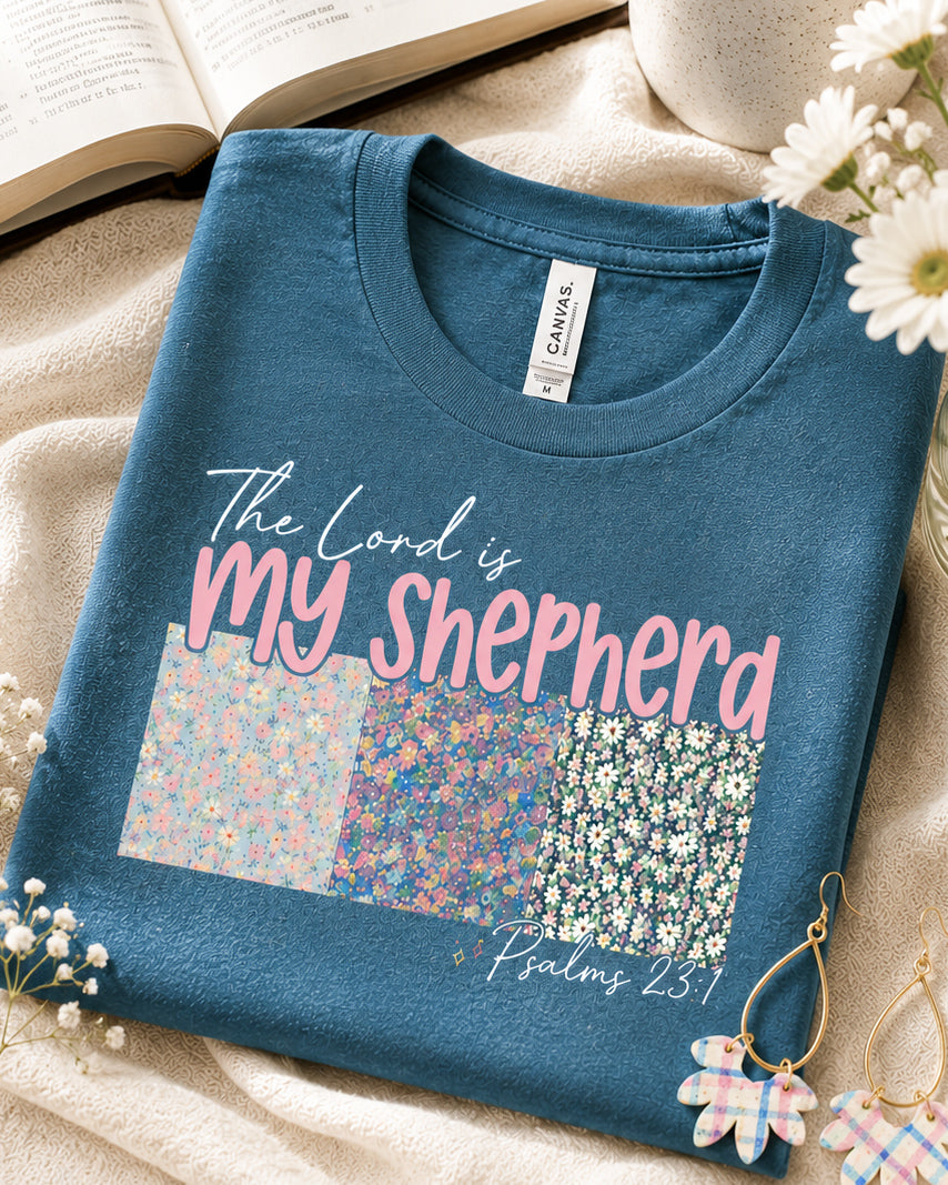 Folded Shepherd's Garden Tee with floral Psalm 23 design on heather deep teal Bella Canvas fabric.