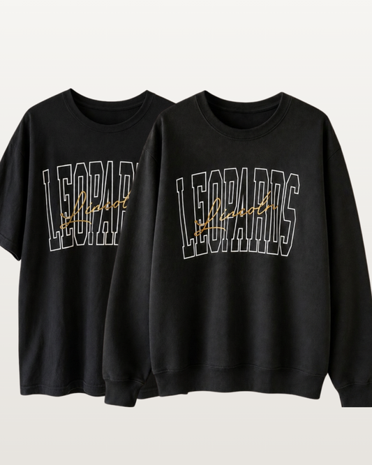 Black Lincoln Leopards graphic shirt shown in both short-sleeve tee and crewneck sweatshirt styles with white outlined varsity lettering and gold script.