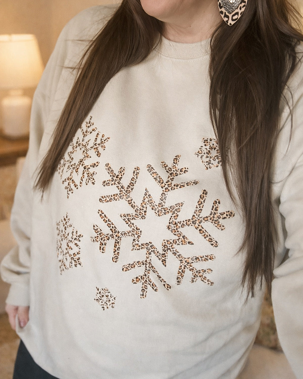 Neutral Snowfall Leopard shirt featuring a leopard snowflake graphic, available as a short sleeve tee or sweatshirt, preorder style