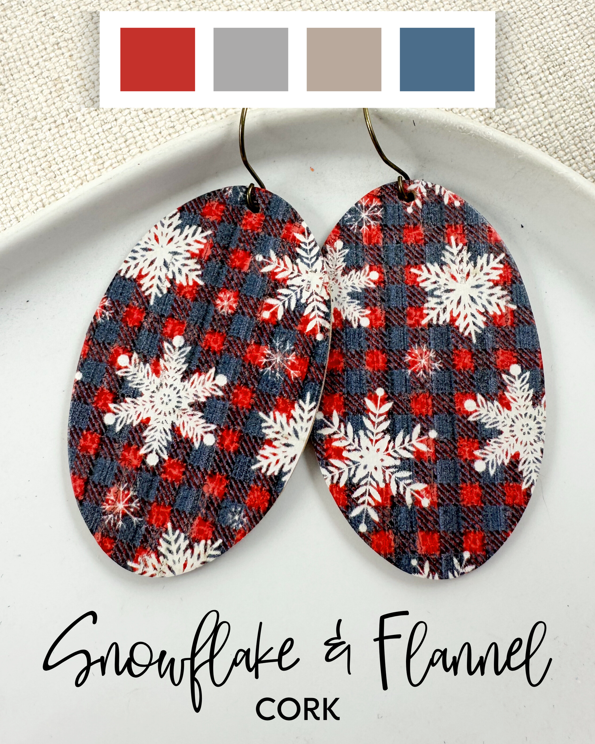 Pair of earrings with snowflake and flannel pattern on a white plate, with color swatches above.