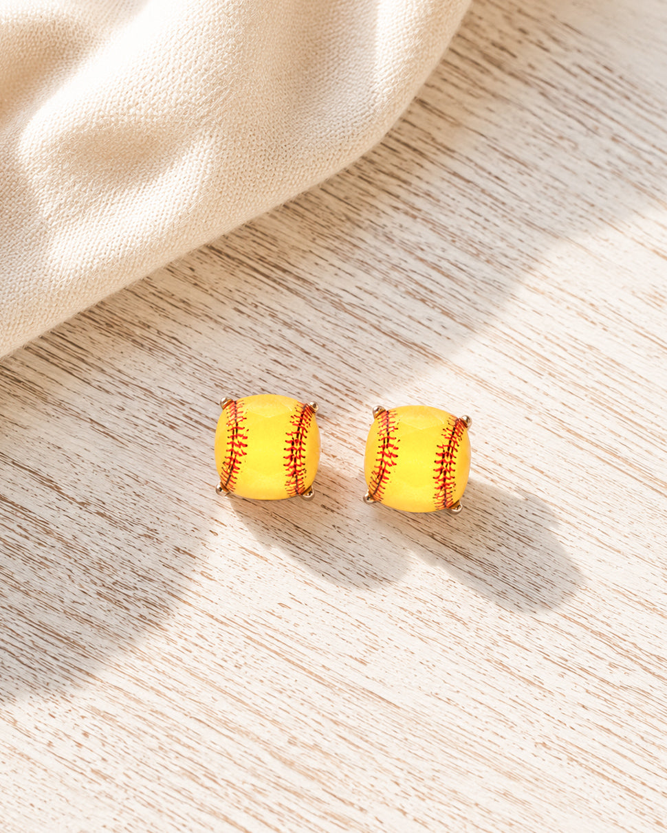 Boutique softball stud earrings displayed on a whitewashed wood surface.