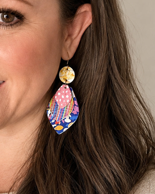 Something Good colorful leather statement earrings modeled to show the 3.5 inch length and lightweight layered design