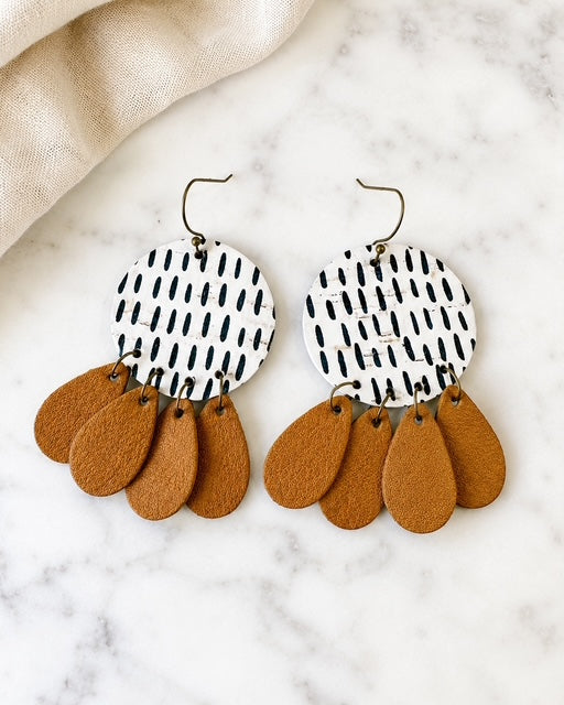 Handmade cork and genuine leather statement earrings with layered leather dangles displayed on white marble.