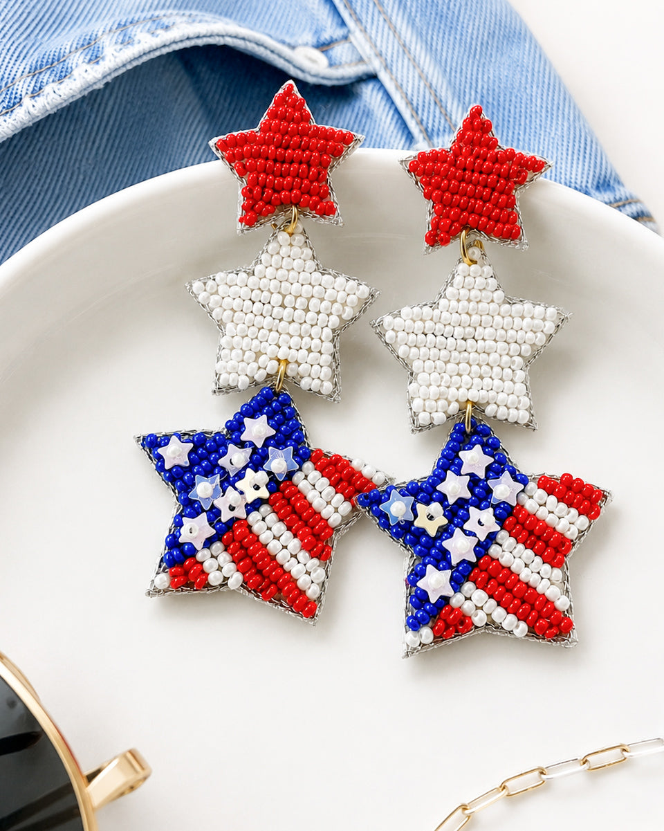 Patriotic red white and blue seed bead star earrings styled with denim and summer accessories