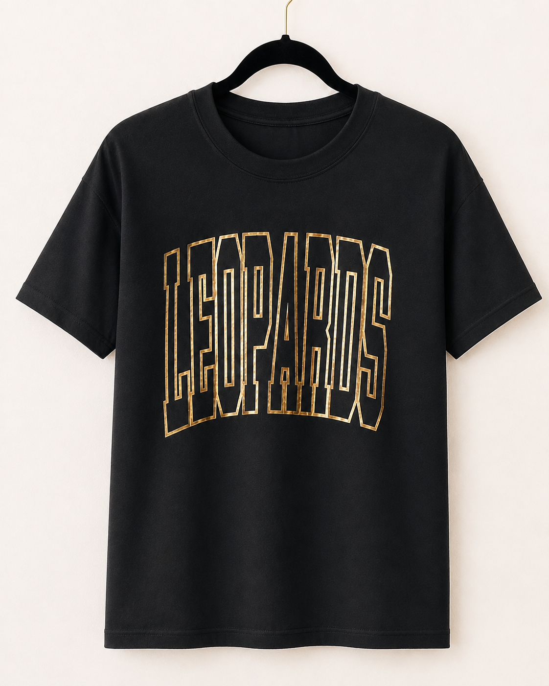 Black Varsity Edit Leopards short sleeve tee with metallic-gold lettering on a hanger
