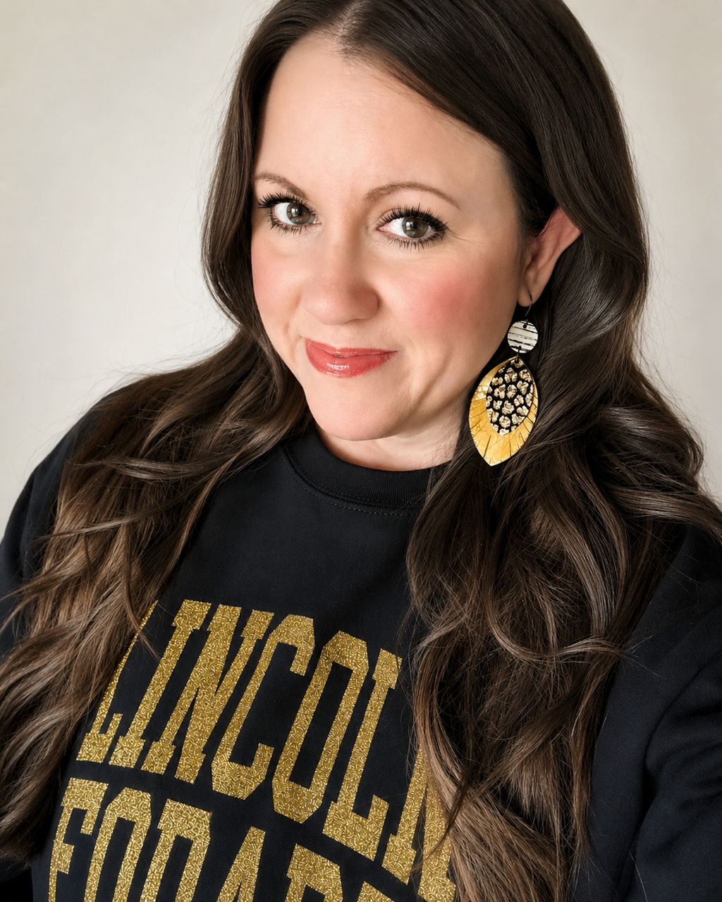 Woman wearing the 4-inch Wild Card Earrings to show their statement length and scale