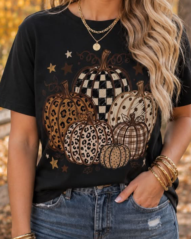Woman wearing the black Wild Pumpkin Patch tee with jeans and layered gold jewelry.
