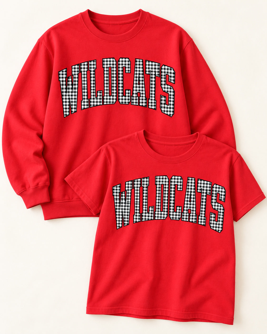 Red Wildcats gingham tee and crewneck sweatshirt displayed together on a creamy neutral background.