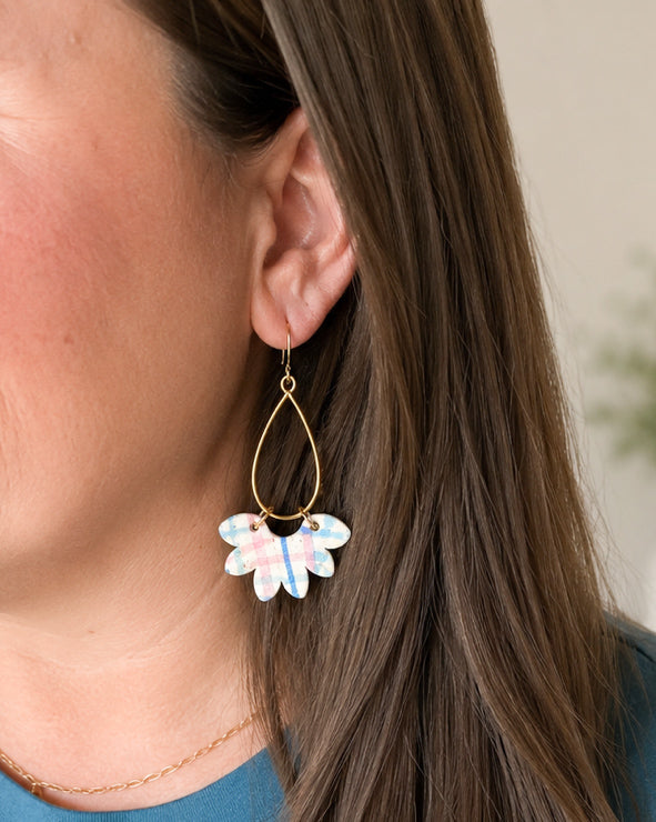 Woman wearing Wildflower Patch handmade cork statement earrings to show size and fit.
