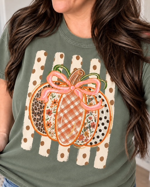 Woman wearing Wildflowers & Gingham Pumpkin Tee on a sage Comfort Colors tee with mixed fall patterns