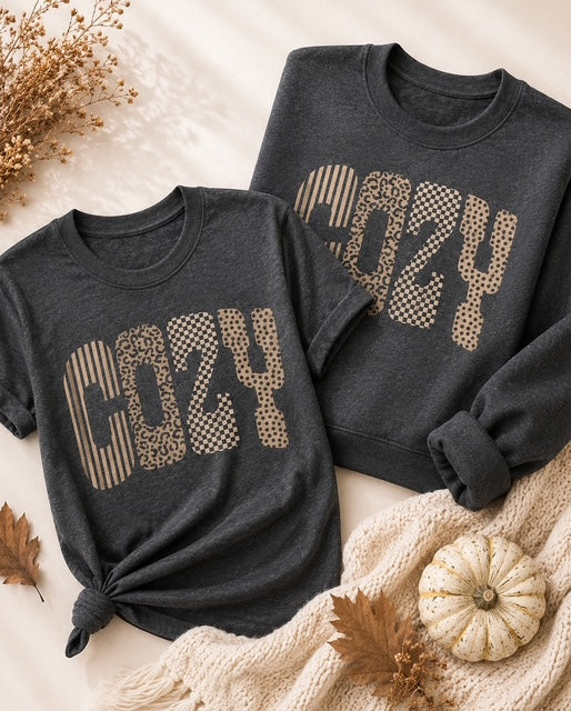 Dark heather gray Wildly Cozy tee and sweatshirt featuring COZY in stripes, leopard, checkerboard and polka dots.