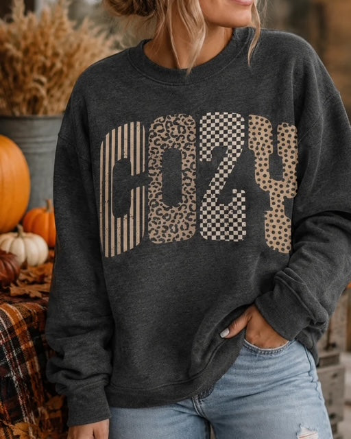 Woman wearing the dark heather gray Wildly Cozy sweatshirt with mixed-print COZY lettering.