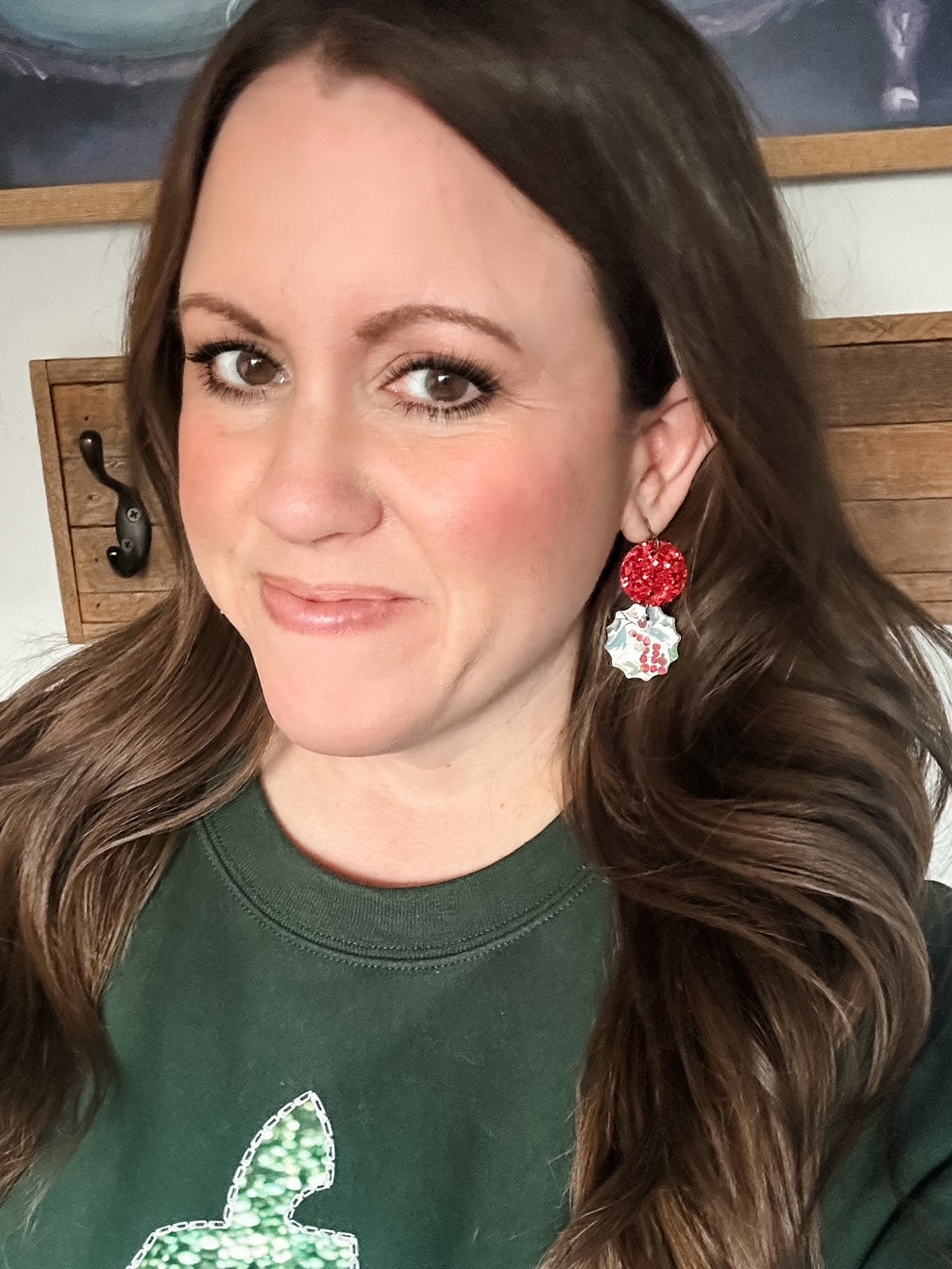 Woman wearing Winterberry Drop Earrings with a red glitter circle and winter berry cork drop.